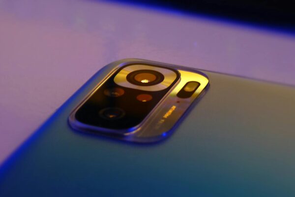 Macro shot of smartphone camera lens highlighting design and technology.